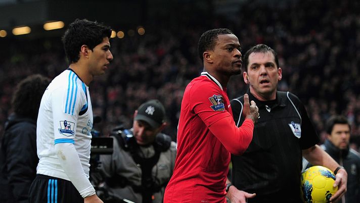MANCHESTER, ENGLAND - FEBRUARY 11: Patrice Evra of Manchester United celebrates victory as he walks off with Luis Suarez of Liverpool during the Barclays Premier League match between Manchester United and Liverpool at Old Trafford on February 11, 2012 in Manchester, England. (Photo by Shaun Botterill/Getty Images) Evra e Suarez