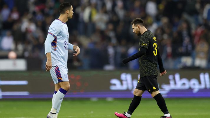 RIYADH, SAUDI ARABIA - JANUARY 19: Lionel Messi of Paris Saint-Germain walks past Cristiano Ronaldo of Riyadh XI after scoring the side's first goal during the Winter Tour 2023 friendly between Paris Saint-Germain and Riyadh XI at King Fahd International Stadium on January 19, 2023 in Riyadh, Saudi Arabia. (Photo by Yasser Bakhsh/Getty Images) Messi Ronaldo