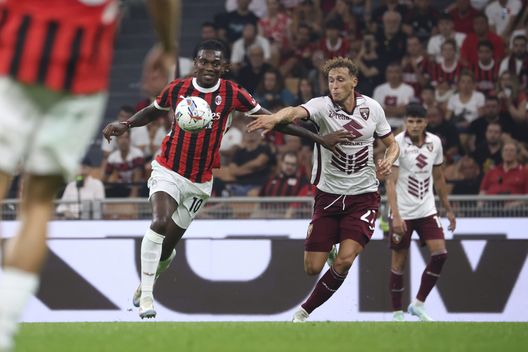 MILAN, ITALY - AUGUST 17: Rafael Leao of AC Milan battling Mergim Vojvoda during the Serie A match between AC Milan and Torino at Stadio Giuseppe Meazza on August 17, 2024 in Milan, Italy. (Photo by Giuseppe Cottini/AC Milan via Getty Images)