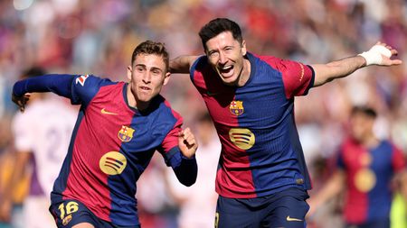 BARCELONA, SPAIN - MARCH 30: Robert Lewandowski of FC Barcelona (R) celebrates scoring his team's second goal with teammate Fermin Lopez during the La Liga EA Sports match between FC Barcelona and Girona FC at Estadi Olimpic Lluis Companys on March 30, 2025 in Barcelona, Spain. (Photo by Judit Cartiel/Getty Images)