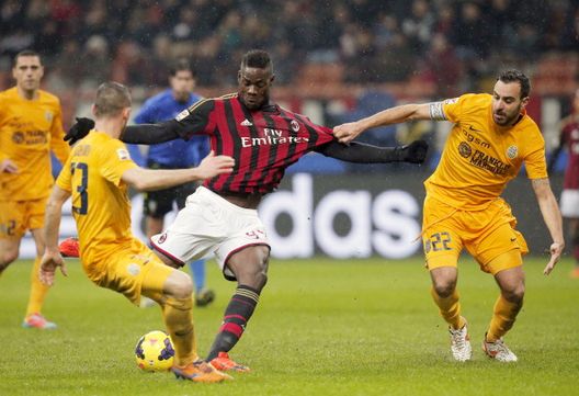 L'attaccante dell'AC Milan Mario Balotelli (al centro) gareggia con il difensore dell'Hellas Verona Matteo Bianchetti (a sinistra) e il difensore dell'Hellas Verona Domenico Maietta durante la partita di calcio della Serie A AC Milan vs Verona allo stadio San Siro di Milano il 19 gennaio 2014 Mario Balotelli