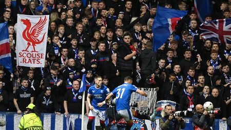 GLASGOW, SCOTLAND - OCTOBER 12: Ranger fans look on as Borna Barisic of Rangers takes a corner kick during the UEFA Champions League group A match between Rangers FC and Liverpool FC at Ibrox Stadium on October 12, 2022 in Glasgow, Scotland. (Photo by Stu Forster/Getty Images)