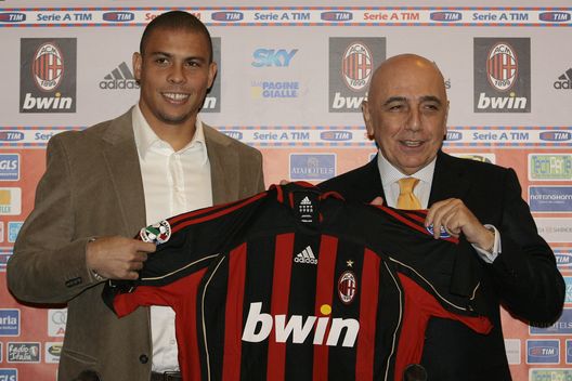 MILAN, ITALY - FEBRUARY 02: Brazilian striker Ronaldo poses with AC Milan Vice President Adriano Galliani and his AC Milan jersey on February 2, 2007 in Milan, Italy. After two weeks of negotiations between Real Madrid and AC Milan, Ronaldo signed an 18-month contract, for 7.5 million euros ($9.7 million). (Photo by Guiseppe Cacace/Getty Images)