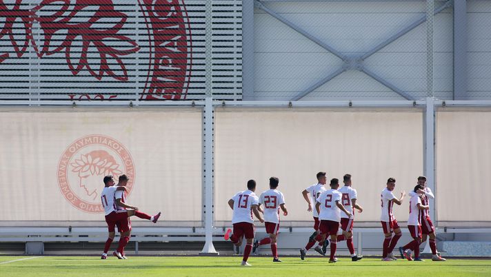 PIRAEUS, GREECE - SEPTEMBER 18: George Fekkas of Olympiacos FC celebrates with team mates after scoring his team's first goal during the UEFA Youth League match between Olympiacos FC and Tottenham Hotspur on September 18, 2019 in Piraeus, Greece. (Photo by Milos Bicanski/Getty Images)
