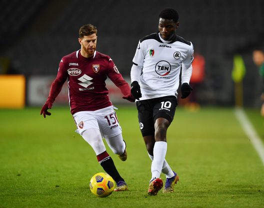 TURIN, ITALY - JANUARY 16: Lucien Agoume of Spezia is challenged by Cristian Ansaldi of Torino during the Serie A match between Torino FC and Spezia Calcio at Stadio Olimpico di Torino on January 16, 2021 in Turin, Italy. Sporting stadiums around Italy remain under strict restrictions due to the Coronavirus Pandemic as Government social distancing laws prohibit fans inside venues resulting in games being played behind closed doors. (Photo by Valerio Pennicino/Getty Images)