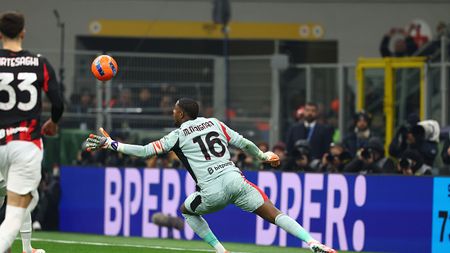 MILAN, ITALY - NOVEMBER 23: Milan goalkeeper Mike Maignan saves a penalty kick taken by Hakan Calhanoglu of FC Internazionale during the Serie A match between FC Internazionale and AC Milan at Giuseppe Meazza Stadium on November 23, 2025 in Milan, Italy. (Photo by Giuseppe Cottini/AC Milan via Getty Images) maignan-vs-calhanoglu