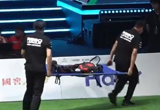 Uno dei robot lascia il campo momentaneamente, infortunato. (Foto dal canale YouTube di RoBoLeague 2025) Anche i robot umanoidi giocano a calcio: primo torneo organizzato in Cina- immagine 2