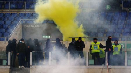 ROME, ITALY - JANUARY 10: A flare is thrown towards the SS Lazio fans in the stands prior to the Coppa Italia match between SS Lazio and AS Roma at Stadio Olimpico on January 10, 2024 in Rome, Italy. (Photo by Paolo Bruno/Getty Images)