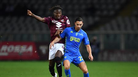 TURIN, ITALY - SEPTEMBER 24: Alieu Eybi Njie of Torino (left) battles for possession with Mattia De Sciglio of Empoli during the Coppa Italia match between Torino FC and Empoli FC at Olimpico Stadium on September 24, 2024 in Turin, Italy. (Photo by Valerio Pennicino/Getty Images)