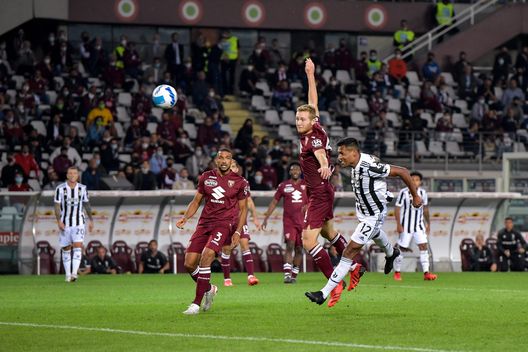 TURIN, ITALY - OCTOBER 02: Alex Sandro of Juventus in action against Tommaso Pobega of Torino FC during the Serie A match between Torino FC v Juventus at Stadio Olimpico di Torino on October 02, 2021 in Turin, Italy. (Photo by Daniele Badolato - Juventus FC/Juventus FC via Getty Images)