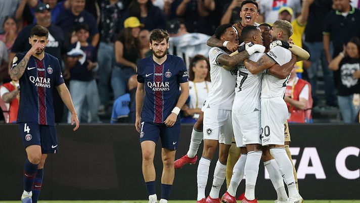 PASADENA, CALIFORNIA - JUNE 19: Players of Botafogo celebrate alongside a dejected Khvicha Kvaratskhelia #7 of Paris Saint-Germain after the team's victory in the FIFA Club World Cup 2025 group B match between Paris Saint-Germain FC and Botafogo FR at Rose Bowl Stadium on June 19, 2025 in Pasadena, California. (Photo by Harry How/Getty Images) Mondiale per Club, il PSG cade con il Botafogo: i brasiliani interrompono una lunga maledizione - immagine 1