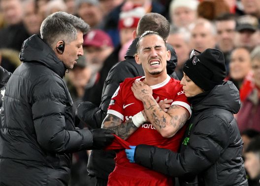 LIVERPOOL, ENGLAND - DECEMBER 23: Kostas Tsimikas of Liverpool receives medical treatment during the Premier League match between Liverpool FC and Arsenal FC at Anfield on December 23, 2023 in Liverpool, England. (Photo by Michael Regan/Getty Images)