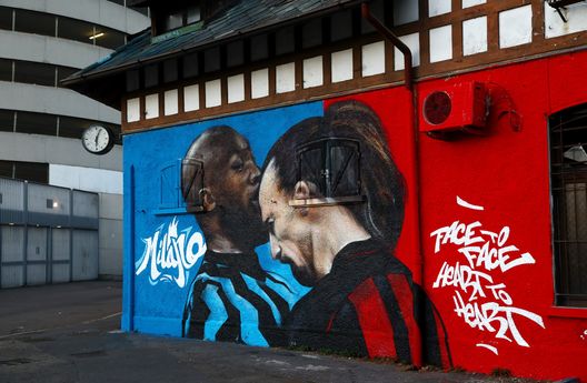 MILAN, ITALY - FEBRUARY 25: A mural is seen on a building outside the stadium of Romelu Lukaku of FC Internazionale as he clashes with Zlatan Ibrahimovic of AC Milan ahead of the UEFA Europa League Round of 32 match between AC Milan and Crvena Zvezda at San Siro Stadium on February 25, 2021 in Milan, Italy. Sporting stadiums around Italy remain under strict restrictions due to the Coronavirus Pandemic as Government social distancing laws prohibit fans inside venues resulting in games being played behind closed doors. (Photo by Marco Luzzani/Getty Images)