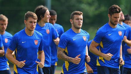 ST ALBANS, ENGLAND - AUGUST 26: Aaron Ramsey of Arsenal warms up with Jack Wilshere during a training session ahead of their UEFA Champions League Play Off second leg match against Fenerbache at London Colney on August 26, 2013 in St Albans, England. (Photo by Michael Regan/Getty Images)