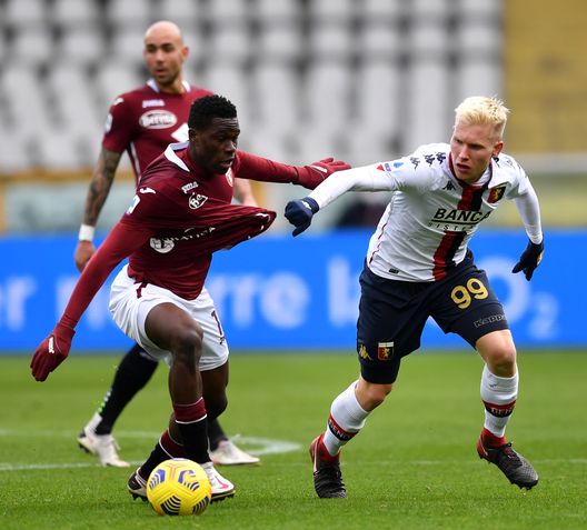 TURIN, ITALY - FEBRUARY 13: Wilfried Singo of Torino FC battles is challenged by Lennart Czyborra of Genoa during the Serie A match between Torino FC and Genoa CFC at Stadio Olimpico di Torino on February 13, 2021 in Turin, Italy. Sporting stadiums around Italy remain under strict restrictions due to the Coronavirus Pandemic as Government social distancing laws prohibit fans inside venues resulting in games being played behind closed doors. (Photo by Valerio Pennicino/Getty Images)