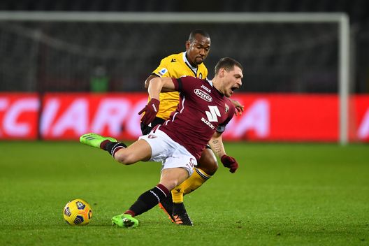 TURIN, ITALY - DECEMBER 12: Andrea Belotti of Torino F.C. is put under pressure by Samir of Udinese Calcio during the Serie A match between Torino FC and Udinese Calcio at Stadio Olimpico di Torino on December 12, 2020 in Turin, Italy. Sporting stadiums around Italy remain under strict restrictions due to the Coronavirus Pandemic as Government social distancing laws prohibit fans inside venues resulting in games being played behind closed doors. (Photo by Valerio Pennicino/Getty Images)
