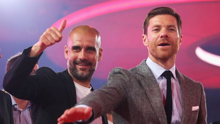 MONACO DI BAVIERA, GERMANIA - 14 MAGGIO: L'allenatore Pep Guardiola (a sinistra) e Xabi Alonso salutano sul palco durante la cena dei campioni della Bundesliga dell'FC Bayern München al Postpalast il 14 maggio 2016 a Monaco di Baviera. (Foto di Lars Baron/Bongarts/Getty Images) Guardiola Xabi Alonso