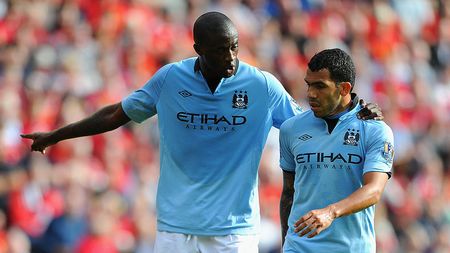 LIVERPOOL, ENGLAND - AUGUST 26: Yaya Toure of Manchester City speaks to team mate Carlos Tevez (R) during the Barclays Premier League match between Liverpool and Manchester City at Anfield on August 26, 2012 in Liverpool, England. (Photo by Michael Regan/Getty Images)