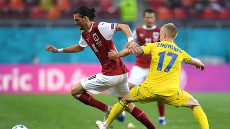 BUCHAREST, ROMANIA - JUNE 21: Florian Grillitsch of Austria runs with the ball whilst under pressure from Oleksandr Zinchenko of Ukraine during the UEFA Euro 2020 Championship Group C match between Ukraine and Austria at National Arena on June 21, 2021 in Bucharest, Romania. (Photo by Daniel Mihailescu - Pool/Getty Images)
