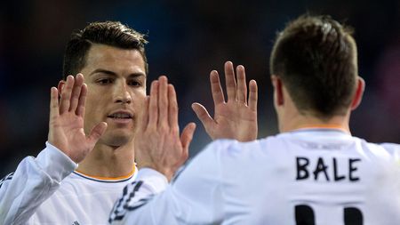 MADRID, SPAIN - FEBRUARY 11: Cristiano Ronaldo (L) of Real Madrid CF clashes hands with his teammate Gareth Bale (R) after a penalty over Bale during the Copa del Rey semi-final second leg match between Club Atletico de Madrid and Real Madrid CF at Vicente Calderon Stadium on February 11, 2014 in Madrid, Spain. (Photo by Gonzalo Arroyo Moreno/Getty Images)