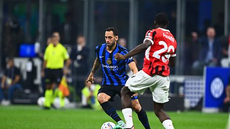 MILAN, ITALY - SEPTEMBER 22: Hakan Calhanoglu of FC Internazionale is challenged by Youssouf Fofana of AC Milan during the Serie A match between FC Internazionale and AC Milan at Stadio Giuseppe Meazza on September 22, 2024 in Milan, Italy. (Photo by Mattia Pistoia - Inter/Inter via Getty Images)