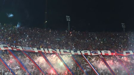 ASUNCION, PARAGUAY - AUGUST 29: Fans of Cerro Porteño cheer their team with flares during a match between Cerro Porteño and River Plate as part of Quarter Finals of Copa CONMEBOL libertadores 2019 at Estadio General Pablo Rojas on August 29, 2019 in Asuncion, Paraguay. (Photo by Luis Vera/Getty Images)