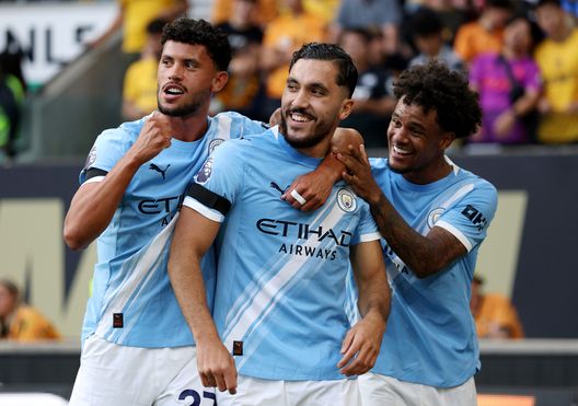 WOLVERHAMPTON, ENGLAND - AUGUST 16: Rayan Cherki of Manchester City celebrates scoring his team's fourth goal with teammates Matheus Nunes and Oscar Bobb during the Premier League match between Wolverhampton Wanderers and Manchester City at Molineux on August 16, 2025 in Wolverhampton, England. (Photo by Michael Regan/Getty Images)