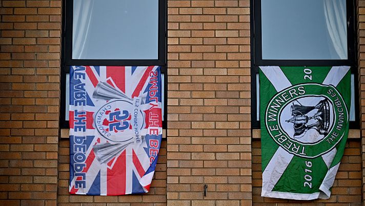 GLASGOW, SCOTLAND - MARCH 21: Flags are seen in a flat near Celtic Park football stadium as arch rivals Celtic and Rangers meet in the Old Firm derby fixture on March 21, 2021 in Glasgow, Scotland. The fixture at Celtic Park was at risk after Rangers fans breached lockdown to celebrate their team's title win. (Photo by Jeff J Mitchell/Getty Images) Maggio, il mese dei derby: danze aperte e rivalità in tutto il mondo - immagine 1