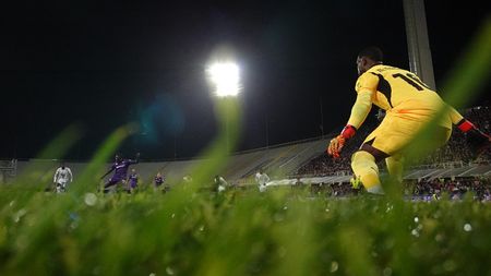 FLORENCE, ITALY - OCTOBER 06: Mike Maignan of AC Milan saves the penalty during the Serie match between Fiorentina and Milan at Stadio Artemio Franchi on October 06, 2024 in Florence, Italy. (Photo by Claudio Villa/AC Milan via Getty Images)