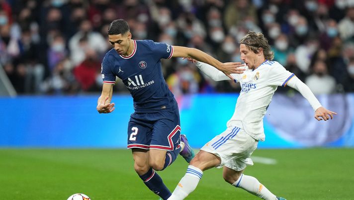 MADRID, SPAIN - MARCH 09: Achraf Hakimi of Paris Saint-Germain is challenged by Luka Modric of Real Madrid during the UEFA Champions League Round Of Sixteen Leg Two match between Real Madrid and Paris Saint-Germain at Estadio Santiago Bernabeu on March 09, 2022 in Madrid, Spain. (Photo by Angel Martinez/Getty Images) real madrid psg