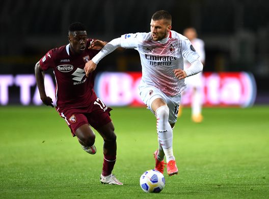 TURIN, ITALY - MAY 12: Ante Rebic of A.C. Milan battles for possession with Wilfried Singo of Torino FC during the Serie A match between Torino FC and AC Milan at Stadio Olimpico di Torino on May 12, 2021 in Turin, Italy. Sporting stadiums around Italy remain under strict restrictions due to the Coronavirus Pandemic as Government social distancing laws prohibit fans inside venues resulting in games being played behind closed doors. (Photo by Valerio Pennicino/Getty Images)