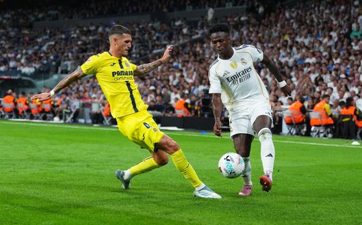 MADRID, SPAIN - OCTOBER 04: Vinicius Junior of Real Madrid is challenged by Rafa Marin of Villarreal CF during the LaLiga EA Sports match between Real Madrid CF and Villarreal CF at Estadio Santiago Bernabeu on October 04, 2025 in Madrid, Spain. (Photo by Angel Martinez/Getty Images)