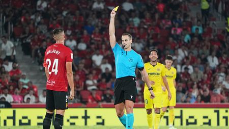 MALLORCA, SPAIN - AUGUST 18: Referee, Javier Alberola Rojas shows a yellow card to Martin Valjent of RCD Mallorca during the LaLiga EA Sports match between RCD Mallorca and Villarreal CF at Estadi de Son Moix on August 18, 2023 in Mallorca, Spain. (Photo by Rafa Babot/Getty Images)