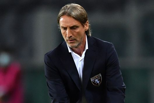 TURIN, ITALY - MAY 12: Davide Nicola, Head Coach of Torino FC attempts to catch the match ball during the Serie A match between Torino FC and AC Milan at Stadio Olimpico di Torino on May 12, 2021 in Turin, Italy. Sporting stadiums around Italy remain under strict restrictions due to the Coronavirus Pandemic as Government social distancing laws prohibit fans inside venues resulting in games being played behind closed doors. (Photo by Valerio Pennicino/Getty Images)