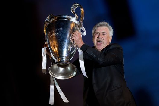 MADRID, SPAIN - MAY 25: Head coach Carlo Ancelotti of Real Madrid CF holds the UEFA Champions League cup celebrating their victory on the UEFA Champions League Final match against Club Atletico de Madrid at Cibeles square on the early morning of May, 25, 2014 in Madrid, Spain. Real Madrid CF achieves their 10th European Cup at Lisbon 12 years later. (Photo by Gonzalo Arroyo Moreno/Getty Images) Carlo Ancelotti