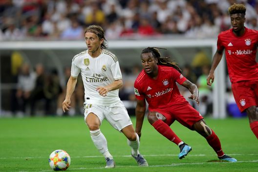HOUSTON, TEXAS - JULY 20: Luka Modric of Real runs with the ball with Renato Sanches of Bayern Muenchen during the International Champions Cup match between Bayern Muenchen and Real Madrid in the 2019 International Champions Cup at NRG Stadium on July 20, 2019 in Houston, Texas. (Photo by Alexander Hassenstein/Bongarts/Getty Images) John Terry ‘intercettato’ a Malpensa commenta Modric al Milan: “Tra i migliori al mondo”- immagine 2