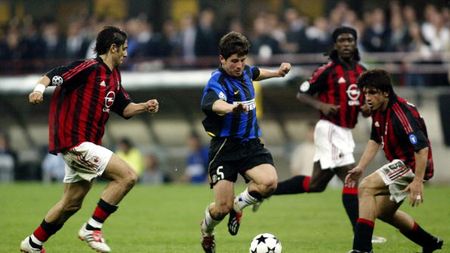 MILAN - MAY 7: Emre Belozoglu of Inter Milan runs with the ball as AC Milan players Rui Costa, Clarence Seedof and Gennaro Gattuso looks to close him down during the UEFA Champions League Semi-Final First Leg match between AC Milan and Internazionale Milano held on May 7, 2003 at the Guiseppe Meazza San Siro, in Milan, Italy. The match ended in a 0-0 draw. (Photo by Michael Steele/Getty Images)