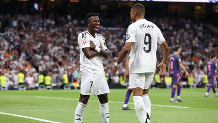 MADRID, SPAIN - SEPTEMBER 21: Vinicius Junior of Real Madrid celebrates with teammate Kylian Mbappe after scoring his team's third goal during the LaLiga match between Real Madrid CF and RCD Espanyol de Barcelona at Estadio Santiago Bernabeu on September 21, 2024 in Madrid, Spain. (Photo by Florencia Tan Jun/Getty Images)